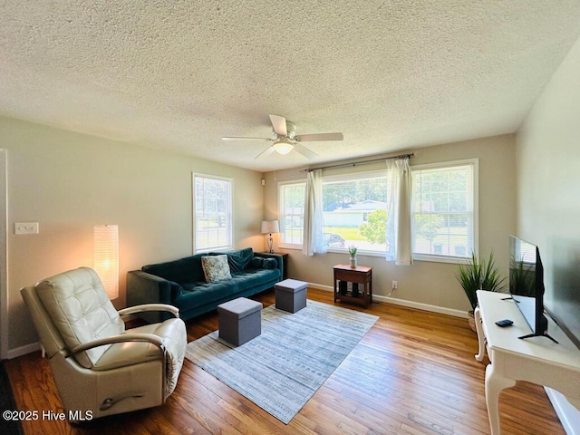 502 Dogwood Ln, Jacksonville, NC 28540 - living room with wood finished floors, a textured ceiling, a ceiling fan, and baseboards