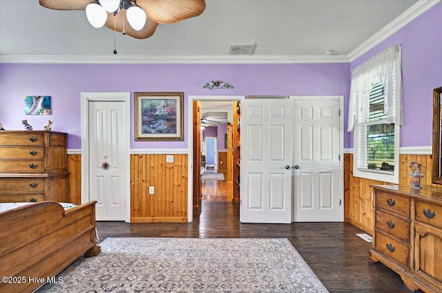 245 Green Bay Rd NW, Ocean Isle Beach, NC 28469 - bedroom with wainscoting, wood finished floors, crown molding, wood walls, and a closet