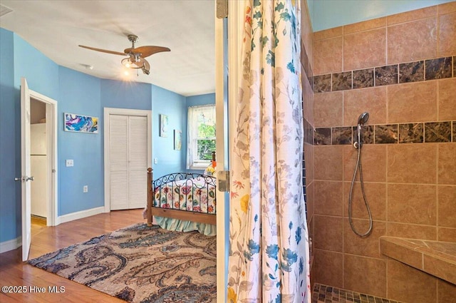 245 Green Bay Rd NW, Ocean Isle Beach, NC 28469 - bedroom featuring wood finished floors, baseboards, a closet, and a ceiling fan