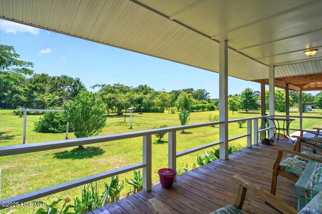 245 Green Bay Rd NW, Ocean Isle Beach, NC 28469 - wooden deck featuring view of wooded area and a lawn
