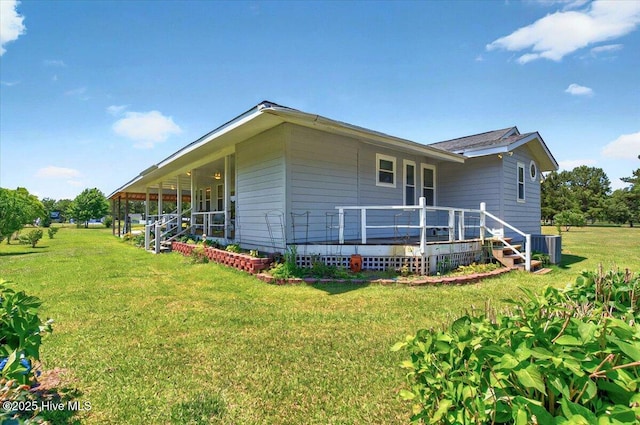 245 Green Bay Rd NW, Ocean Isle Beach, NC 28469 - view of side of home featuring a yard, a wooden deck, and central AC