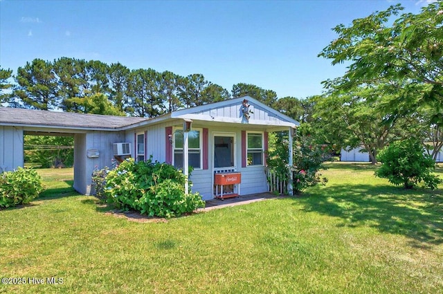 245 Green Bay Rd NW, Ocean Isle Beach, NC 28469 - view of front of house featuring a front lawn and a wall mounted air conditioner