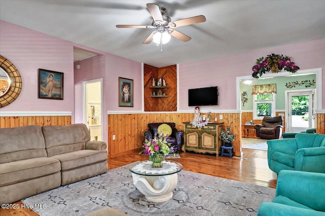 245 Green Bay Rd NW, Ocean Isle Beach, NC 28469 - living room featuring a wainscoted wall, wooden walls, ceiling fan, and wood finished floors