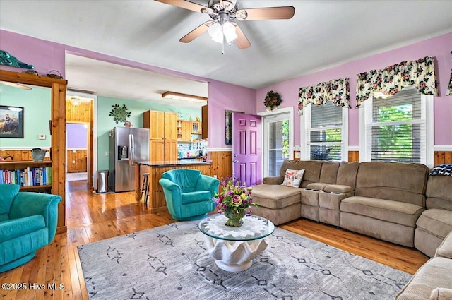 245 Green Bay Rd NW, Ocean Isle Beach, NC 28469 - living area featuring light wood-style flooring, ceiling fan, and wainscoting