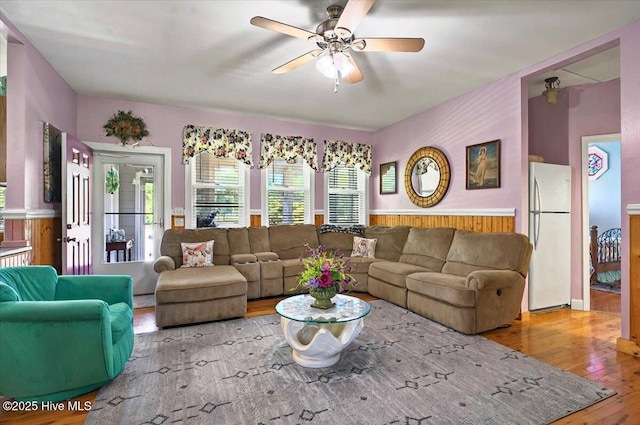 245 Green Bay Rd NW, Ocean Isle Beach, NC 28469 - living room featuring hardwood / wood-style flooring, a ceiling fan, wainscoting, and wooden walls