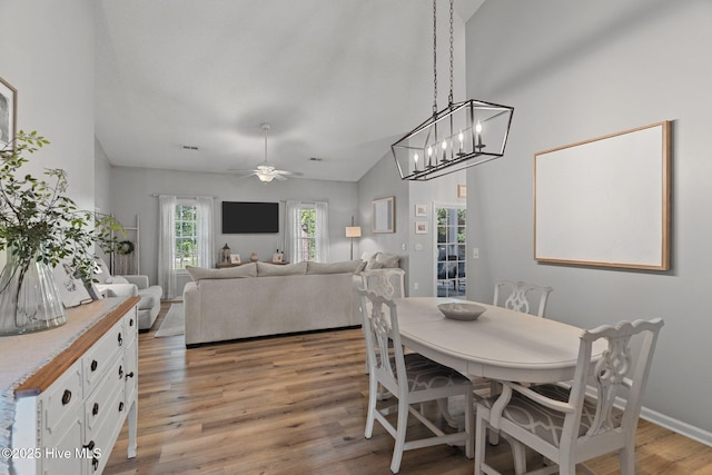 817 Glenarthur Dr, Wilmington, NC 28412 - dining space with light wood-type flooring, a ceiling fan, a chandelier, and lofted ceiling