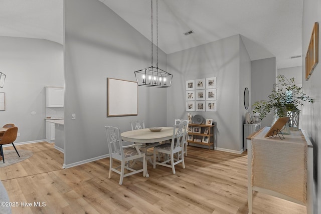 817 Glenarthur Dr, Wilmington, NC 28412 - dining area with high vaulted ceiling, light wood finished floors, baseboards, and a chandelier