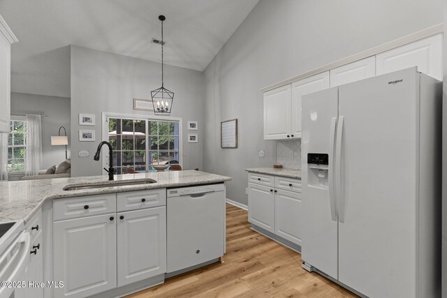 817 Glenarthur Dr, Wilmington, NC 28412 - kitchen with white appliances, a sink, a chandelier, a towering ceiling, and hanging light fixtures