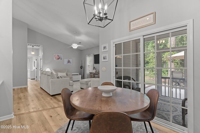 817 Glenarthur Dr, Wilmington, NC 28412 - dining space featuring light wood-style flooring, high vaulted ceiling, a chandelier, ceiling fan, and baseboards
