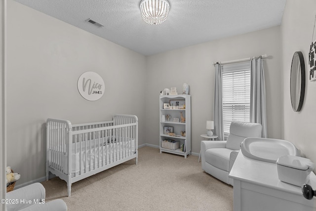 817 Glenarthur Dr, Wilmington, NC 28412 - carpeted bedroom with a crib, a textured ceiling, and baseboards