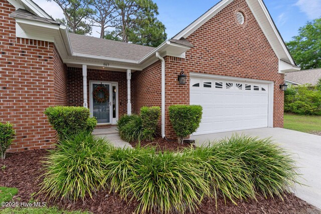 817 Glenarthur Dr, Wilmington, NC 28412 - view of front facade featuring brick siding, a garage, driveway, and a shingled roof