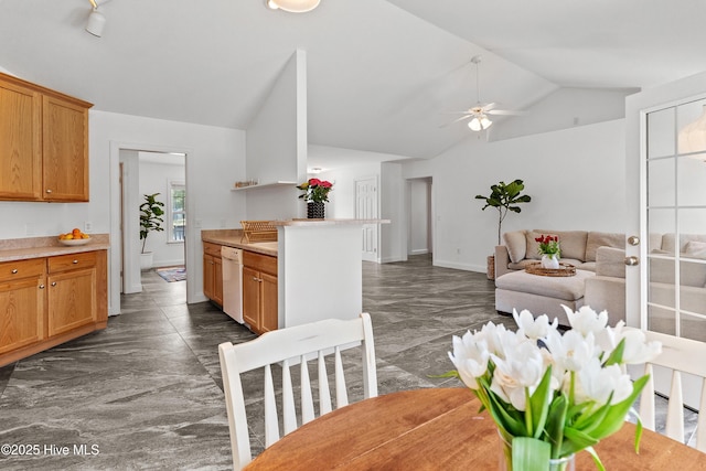 5018 Summerswell Ln, Southport, NC 28461 - kitchen featuring white dishwasher, vaulted ceiling, dark marble finish flooring, a ceiling fan, and light countertops