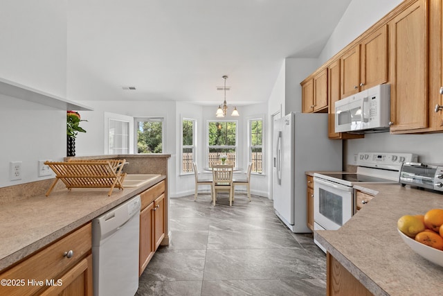 5018 Summerswell Ln, Southport, NC 28461 - kitchen with white appliances, a chandelier, and hanging light fixtures