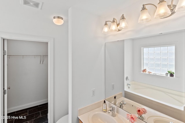 5018 Summerswell Ln, Southport, NC 28461 - full bath with vanity, toilet, a bathtub, and a walk in closet