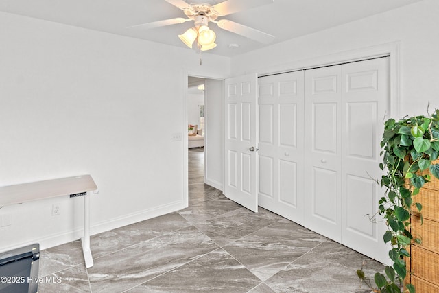 5018 Summerswell Ln, Southport, NC 28461 - unfurnished bedroom featuring marble finish flooring, baseboards, a closet, and ceiling fan