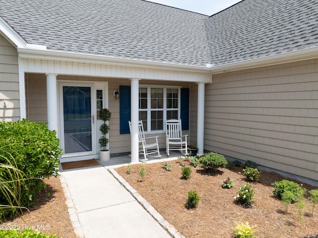 5018 Summerswell Ln, Southport, NC 28461 - doorway to property featuring a porch and a shingled roof