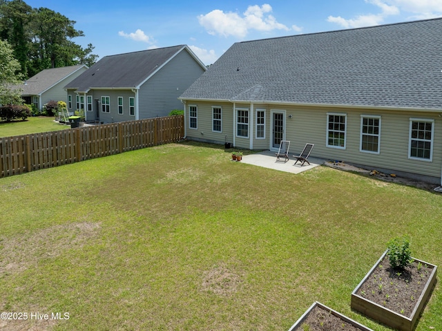 5018 Summerswell Ln, Southport, NC 28461 - back of house featuring a vegetable garden, a patio, and a shingled roof