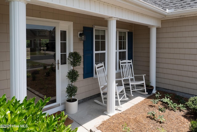 5018 Summerswell Ln, Southport, NC 28461 - entrance to property featuring a shingled roof and covered porch