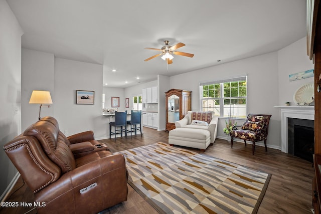 4345 Nine Iron Dr, Ayden, NC 28513 - living area with ceiling fan, a fireplace, dark wood finished floors, baseboards, and recessed lighting