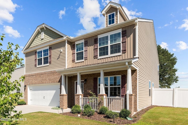 4345 Nine Iron Dr, Ayden, NC 28513 - view of front of house with covered porch, brick siding, a garage, concrete driveway, and board and batten siding