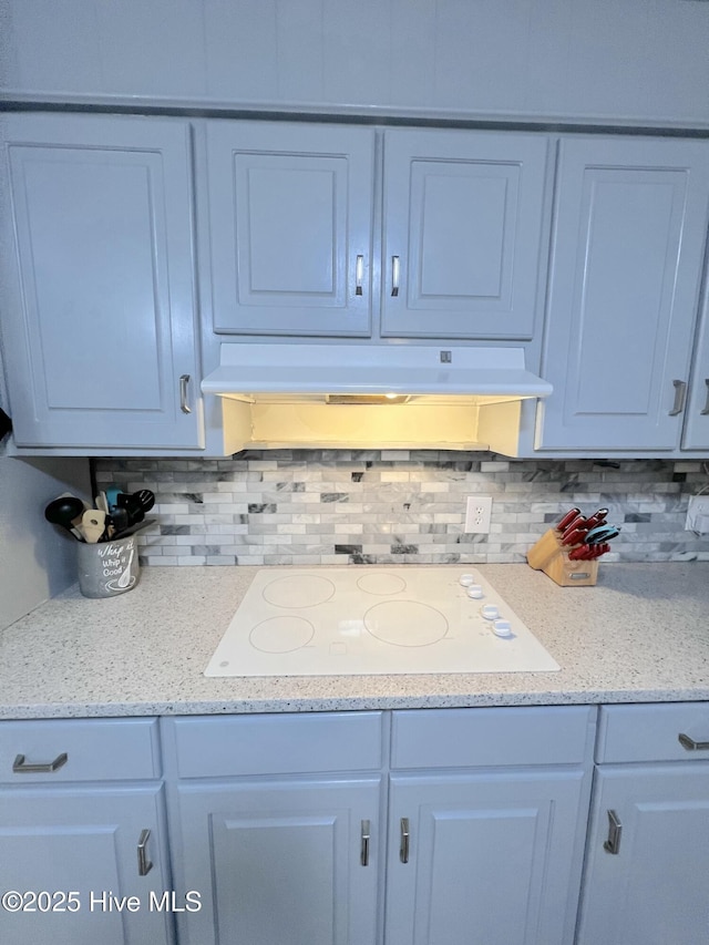 1811 Hermitage Rd NW, Wilson, NC 27896 - kitchen with white stovetop, under cabinet range hood, and decorative backsplash