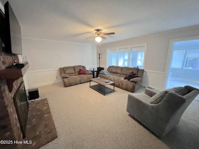 1811 Hermitage Rd NW, Wilson, NC 27896 - carpeted living room featuring plenty of natural light, a wainscoted wall, and ceiling fan