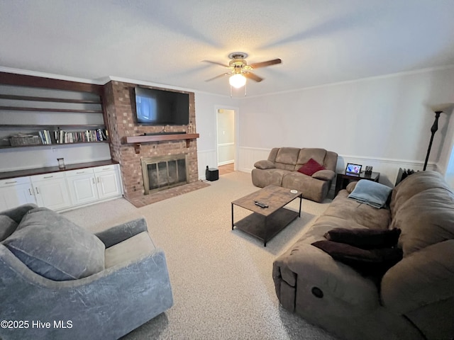 1811 Hermitage Rd NW, Wilson, NC 27896 - living room with ceiling fan, carpet flooring, a fireplace, and a wainscoted wall