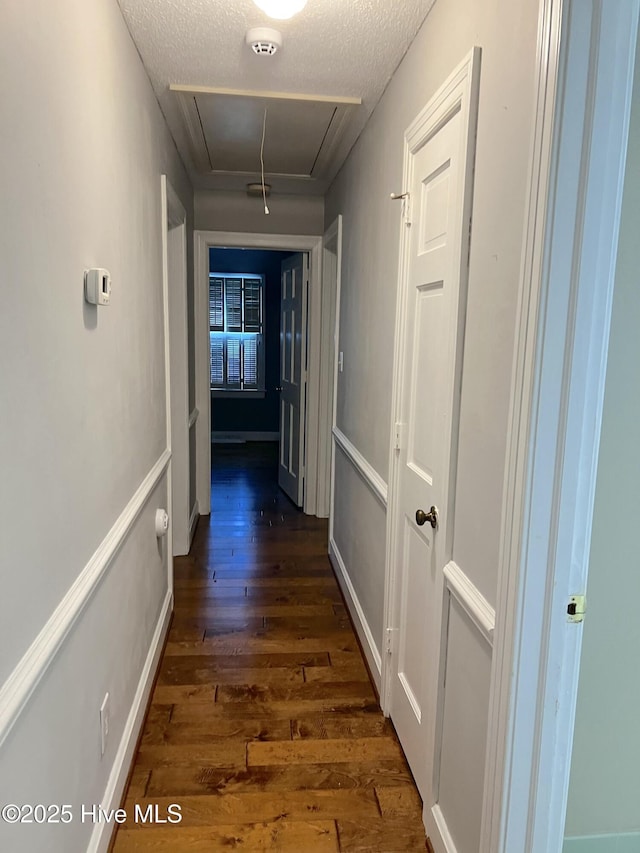 1811 Hermitage Rd NW, Wilson, NC 27896 - corridor featuring attic access, dark wood-type flooring, a textured ceiling, and baseboards