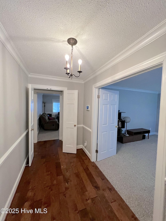 1811 Hermitage Rd NW, Wilson, NC 27896 - hallway with a textured ceiling, wood finished floors, ornamental molding, a chandelier, and baseboards