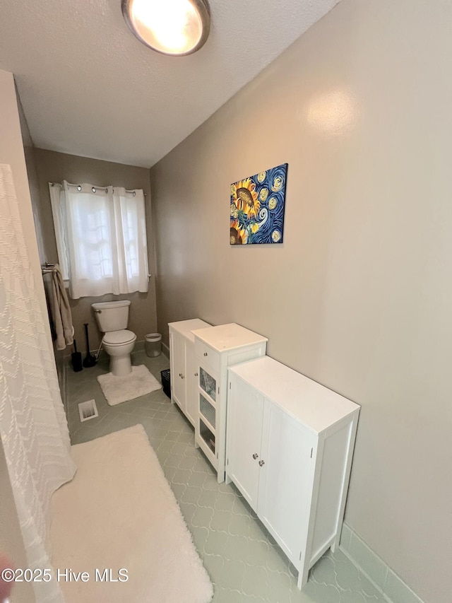 1811 Hermitage Rd NW, Wilson, NC 27896 - bathroom featuring toilet and baseboards
