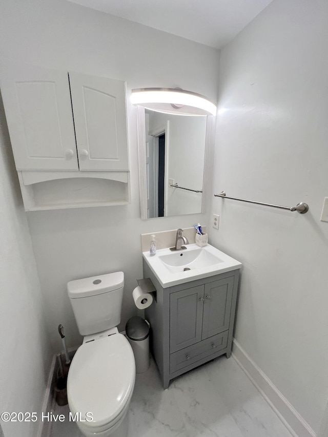 1811 Hermitage Rd NW, Wilson, NC 27896 - half bathroom featuring vanity, toilet, marble finish flooring, and baseboards
