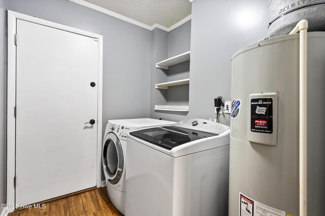 716 Shadowridge Rd, Jacksonville, NC 28546 - laundry room featuring water heater, ornamental molding, washing machine and dryer, wood finished floors, and a textured ceiling