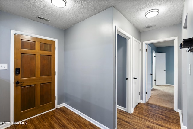 716 Shadowridge Rd, Jacksonville, NC 28546 - entryway featuring dark wood-style flooring, baseboards, and a textured ceiling