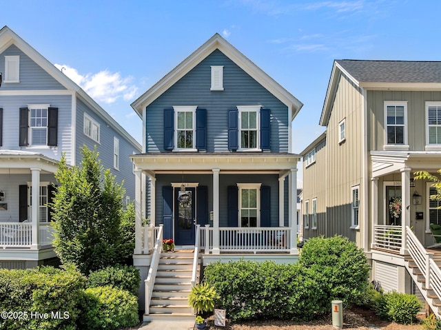 233 E Water St, Washington, NC 27889 - view of front of house featuring covered porch, stairway, and board and batten siding