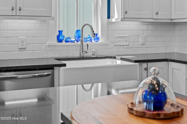 233 E Water St, Washington, NC 27889 - kitchen featuring dishwasher, a sink, tasteful backsplash, white cabinets, and dark stone counters