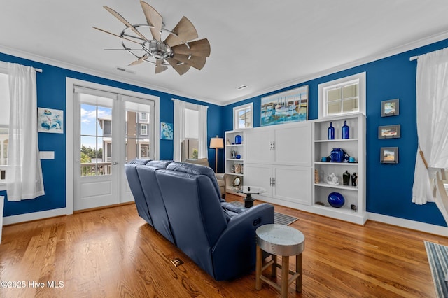 233 E Water St, Washington, NC 27889 - living room featuring wood finished floors, ceiling fan, ornamental molding, baseboards, and french doors