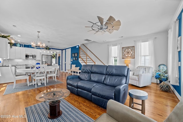 233 E Water St, Washington, NC 27889 - living area featuring a chandelier, ceiling fan, light wood-style flooring, stairway, and recessed lighting