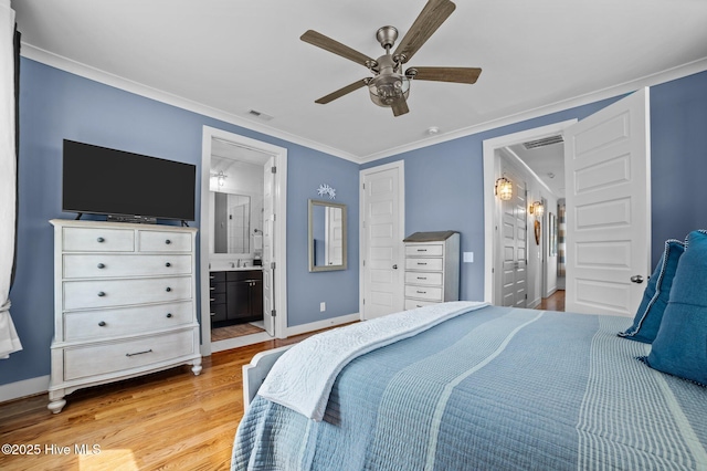 233 E Water St, Washington, NC 27889 - bedroom with light wood-type flooring, ensuite bath, baseboards, ornamental molding, and ceiling fan