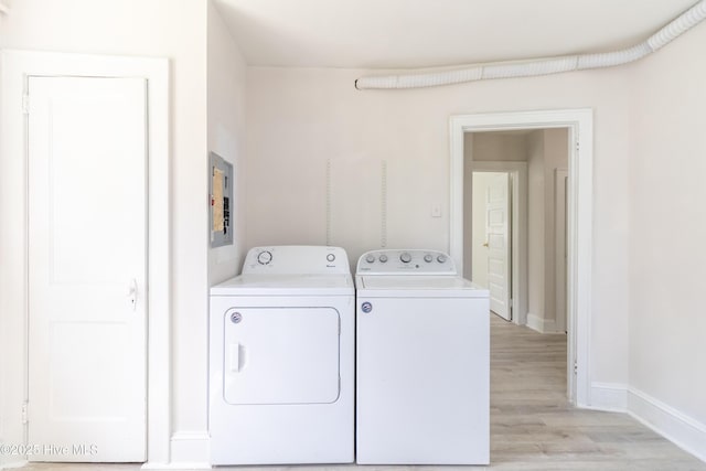 808 Cabarrus St, Edenton, NC 27932 - laundry room featuring washing machine and dryer, light wood-style flooring, baseboards, and electric panel