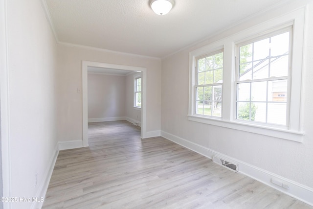 808 Cabarrus St, Edenton, NC 27932 - spare room with ornamental molding, light wood finished floors, baseboards, and a textured ceiling