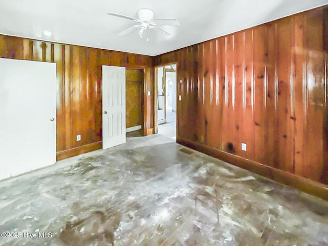 101 W Pearl St, Aulander, NC 27805 - unfurnished room featuring ceiling fan, wooden walls, and concrete floors