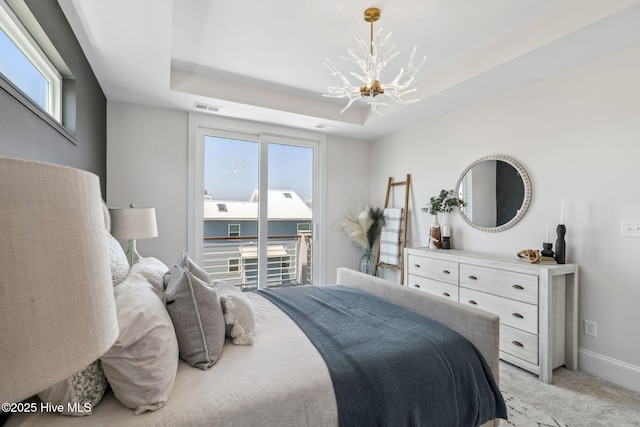 221 Georgia Ave, Carolina Beach, NC 28428 - bedroom with a chandelier, access to exterior, multiple windows, and light colored carpet
