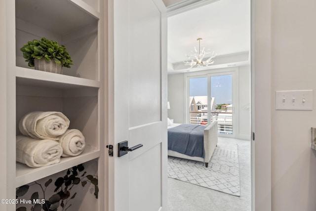 221 Georgia Ave, Carolina Beach, NC 28428 - bedroom featuring a chandelier, light colored carpet, and access to exterior