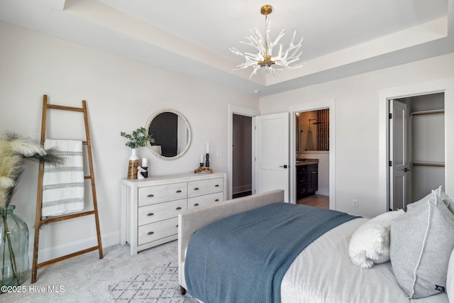 221 Georgia Ave, Carolina Beach, NC 28428 - bedroom featuring a chandelier, baseboards, a tray ceiling, and light colored carpet