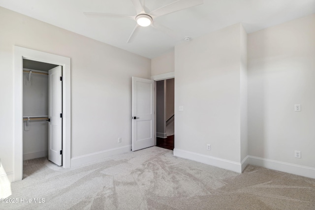 221 Georgia Ave, Carolina Beach, NC 28428 - unfurnished bedroom with carpet floors, baseboards, a walk in closet, a closet, and ceiling fan
