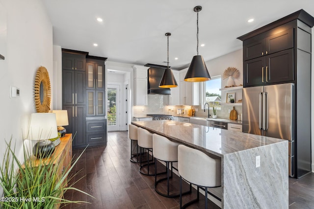 221 Georgia Ave, Carolina Beach, NC 28428 - kitchen with stainless steel appliances, premium range hood, a center island, backsplash, and recessed lighting