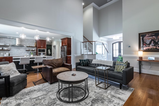 509 Westminster Cir, Greenville, NC 27858 - living area with stairway, a towering ceiling, wood finished floors, ornamental molding, and recessed lighting