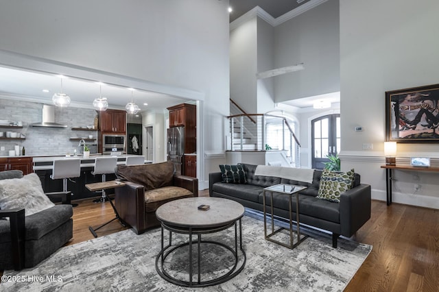 509 Westminster Cir, Greenville, NC 27858 - living area featuring a towering ceiling, stairway, wood finished floors, crown molding, and recessed lighting