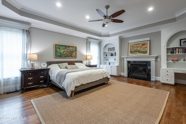 509 Westminster Cir, Greenville, NC 27858 - bedroom featuring a tray ceiling, a premium fireplace, ornamental molding, dark wood finished floors, and recessed lighting