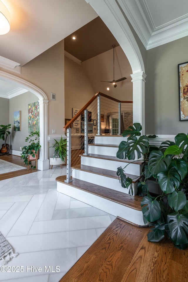 509 Westminster Cir, Greenville, NC 27858 - staircase with arched walkways, crown molding, decorative columns, and ceiling fan
